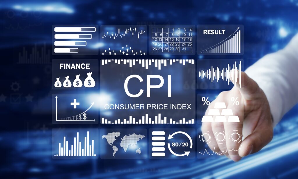 Man in a button-down shirt pointing at CPI inflation graphs on a digital screen, representing U.S. consumer price data and economic analysis.